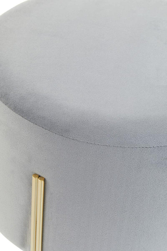 Round grey velvet stool with a smooth top surface and gold metal legs, showcasing a modern and elegant design