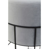 Round velvet stool in a light gray color, featuring a sleek black metal cage frame. The design showcases a smooth, plush top and a minimalist structure with four slender legs