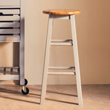 Natural wood seat with a light grey wooden frame, featuring four legs and a simple design, positioned next to a metal cart in a softly lit room