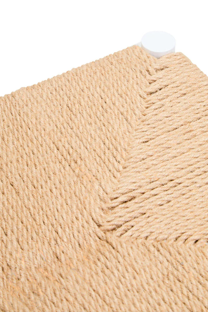 Close-up of woven rope seat detail with natural jute texture and white corner foot