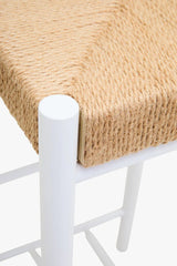 Closeup of woven rope seat on white metal chair