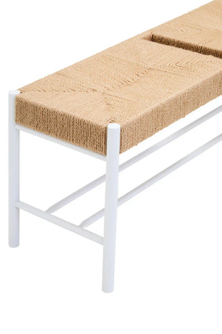 Woven rope bench seat on white metal frame, close-up of texture and leg detail