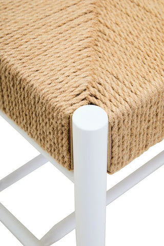 Close view of woven rope seat on white metal chair