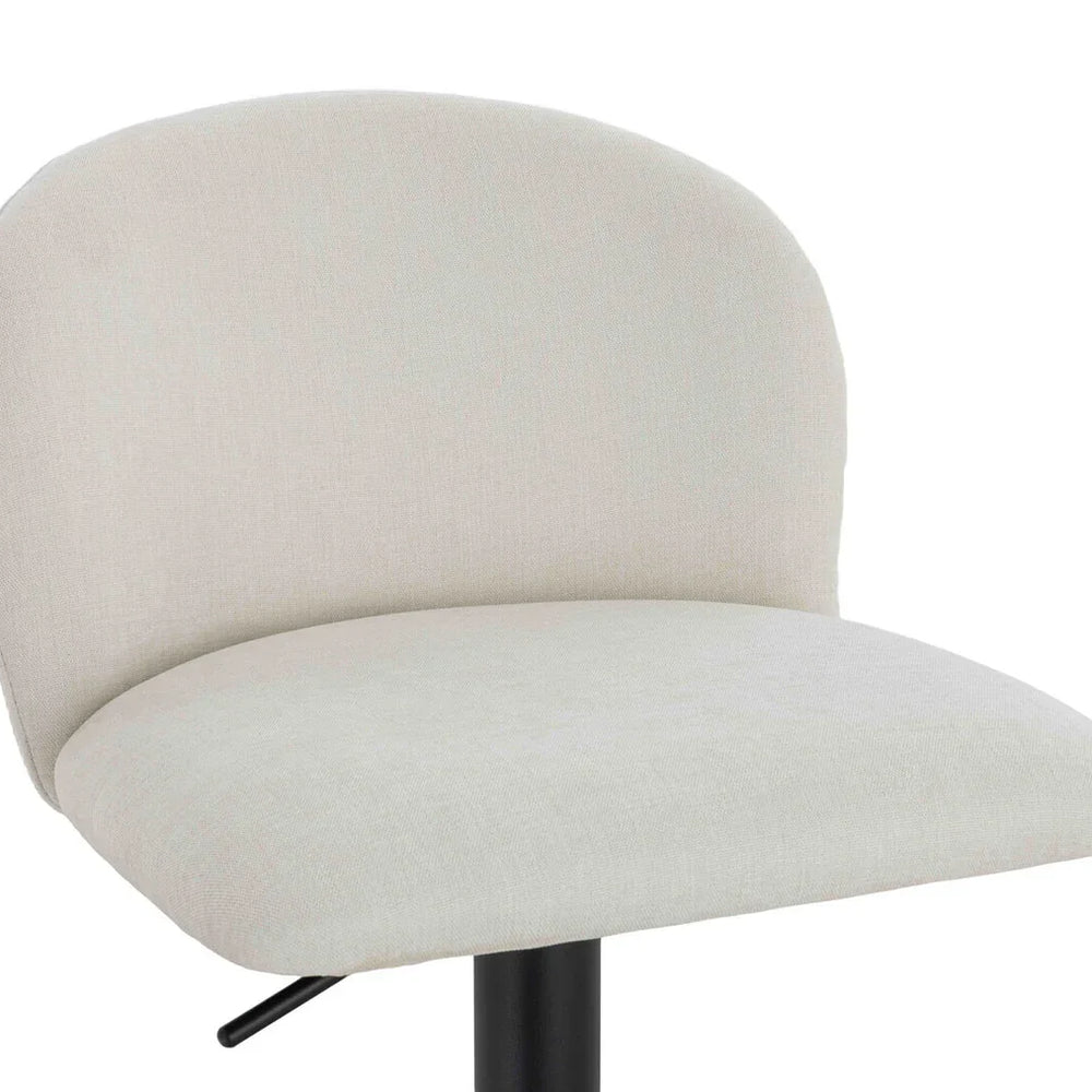 Cream fabric bar stool with curved backrest and black metal base, close-up view