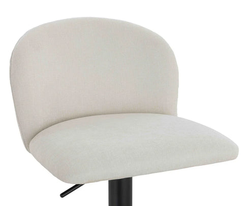 Cream fabric bar stool with curved backrest and black metal base, close-up view