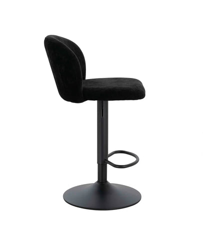 Black velvet bar stool with curved backrest and metal base, side profile view