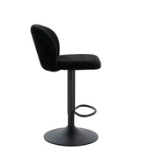Black velvet bar stool with curved backrest and metal base, side profile view