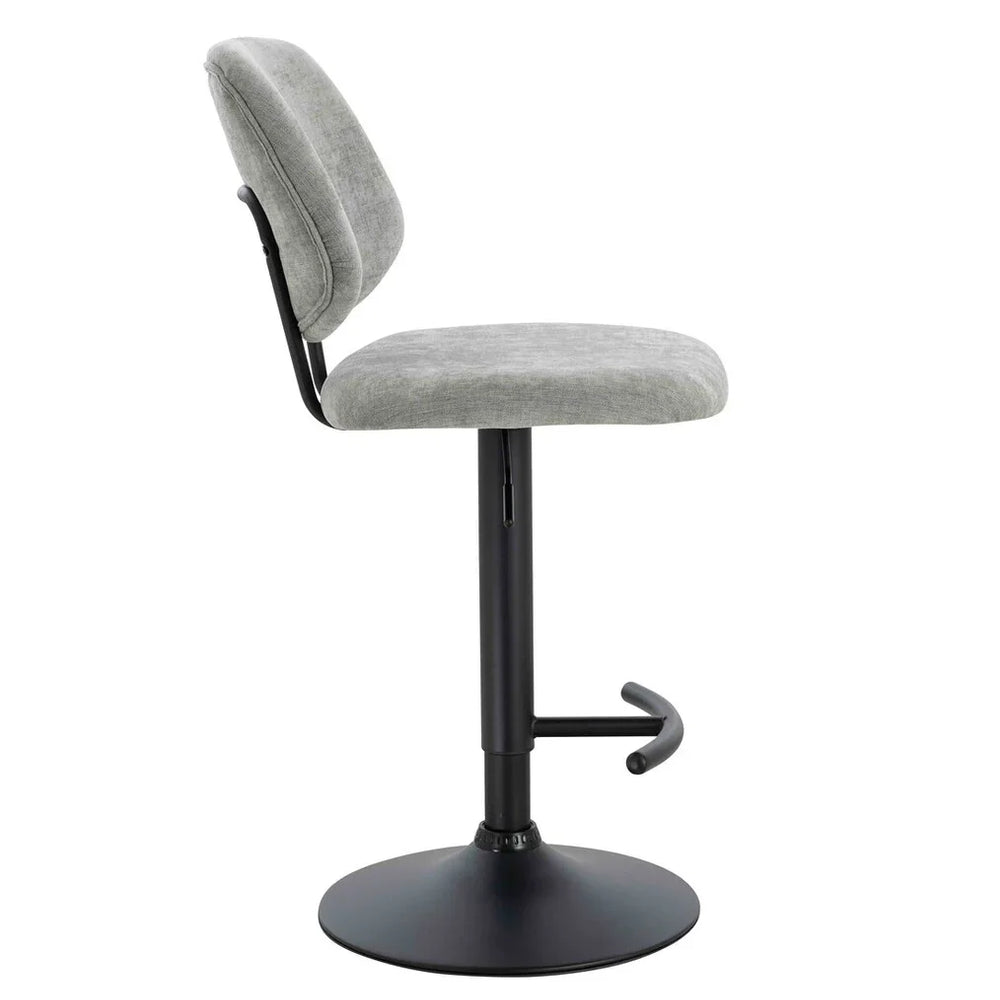 Grey fabric bar stool with cushioned seat, black pedestal base, and footrest side view