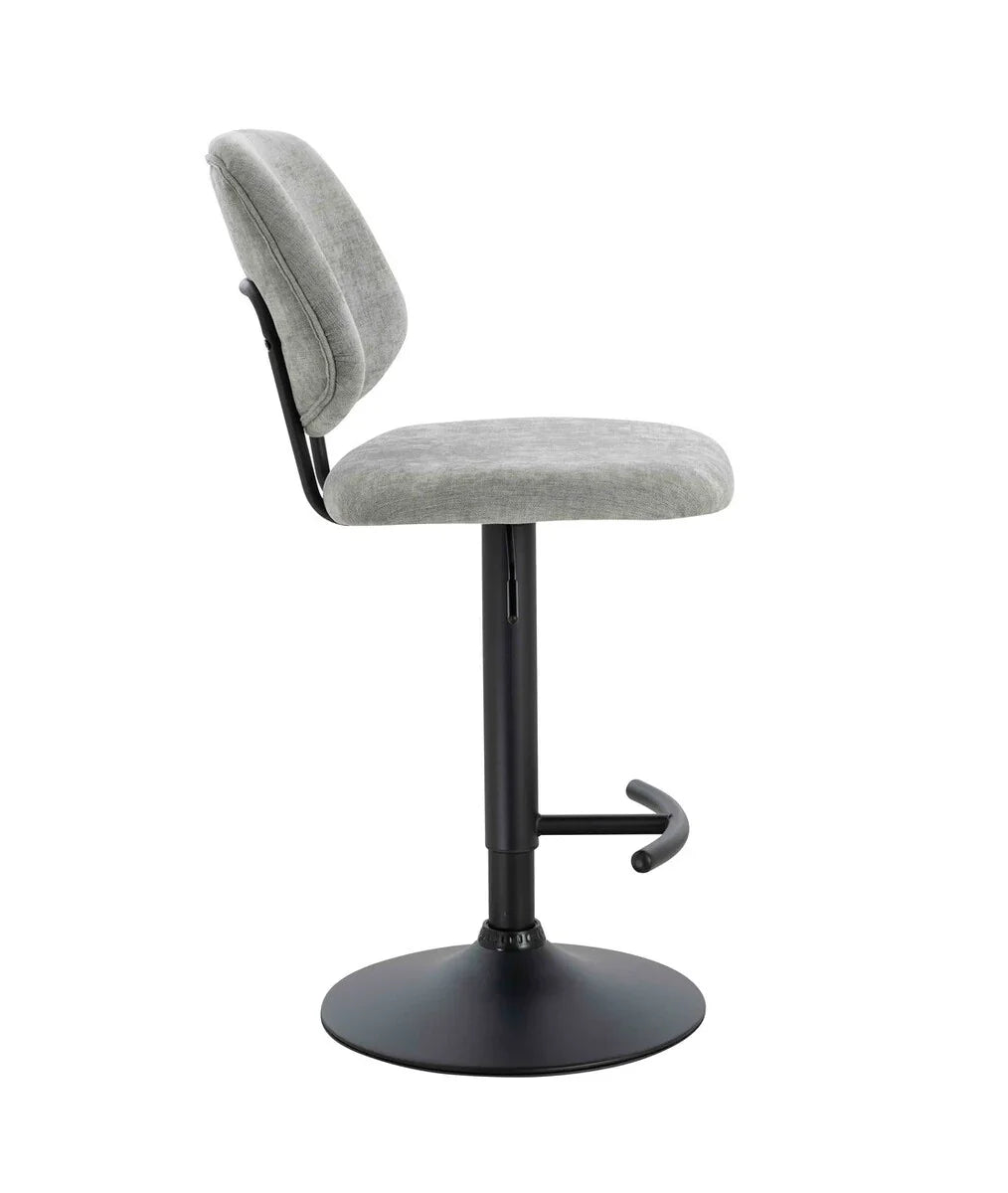 Grey fabric bar stool with cushioned seat, black pedestal base, and footrest side view