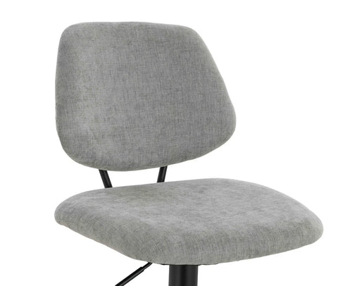 Grey fabric dining chair with cushioned seat and backrest on black metal legs