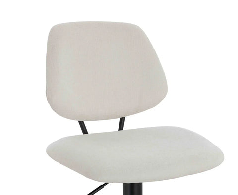 Light beige fabric dining chair with black metal legs, close up of backrest and seat