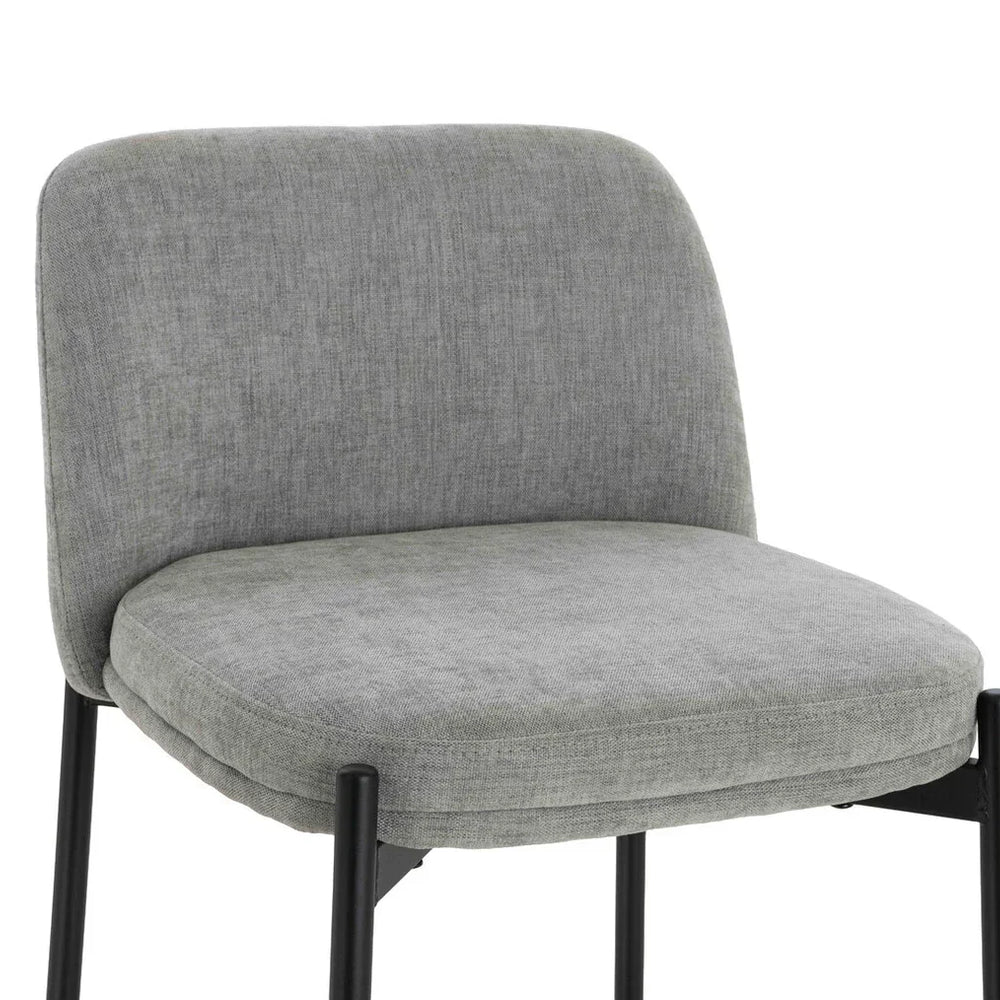 Grey fabric dining chair with cushioned seat and black metal legs, front angle view