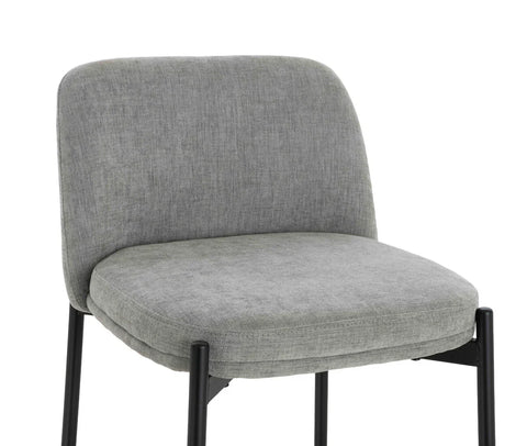 Grey fabric dining chair with cushioned seat and black metal legs, front angle view