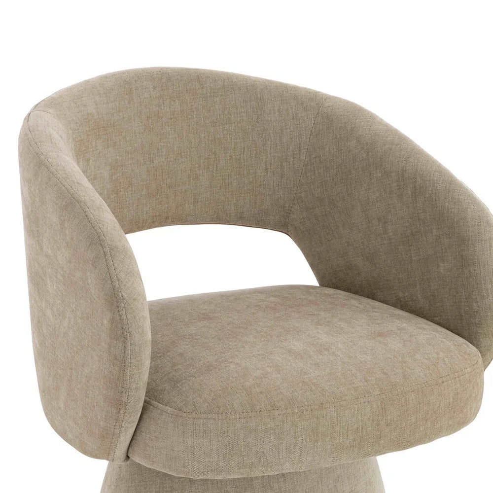 Beige fabric accent chair with curved backrest and wide cushioned seat, side angle view