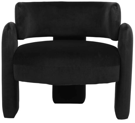 Curved black velvet chair featuring plush upholstery, rounded armrests, and a sturdy base.