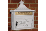 White cast iron post box with gold letter slot, horse design, wall mounted on brick exterior
