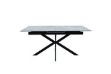 A modern rectangular dining table with a light gray stone-look top and a black metal X-shaped base, shown against a plain white background.
