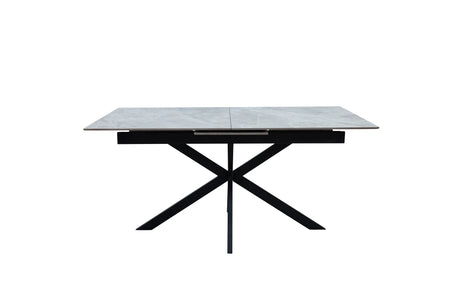A modern rectangular dining table with a light gray stone-look top and a black metal X-shaped base, shown against a plain white background.