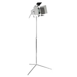 Chrome floor lamp with adjustable tripod base and industrial spotlight head