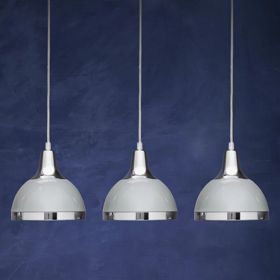 Set of three chrome pendant lights with white shades against a dark blue background