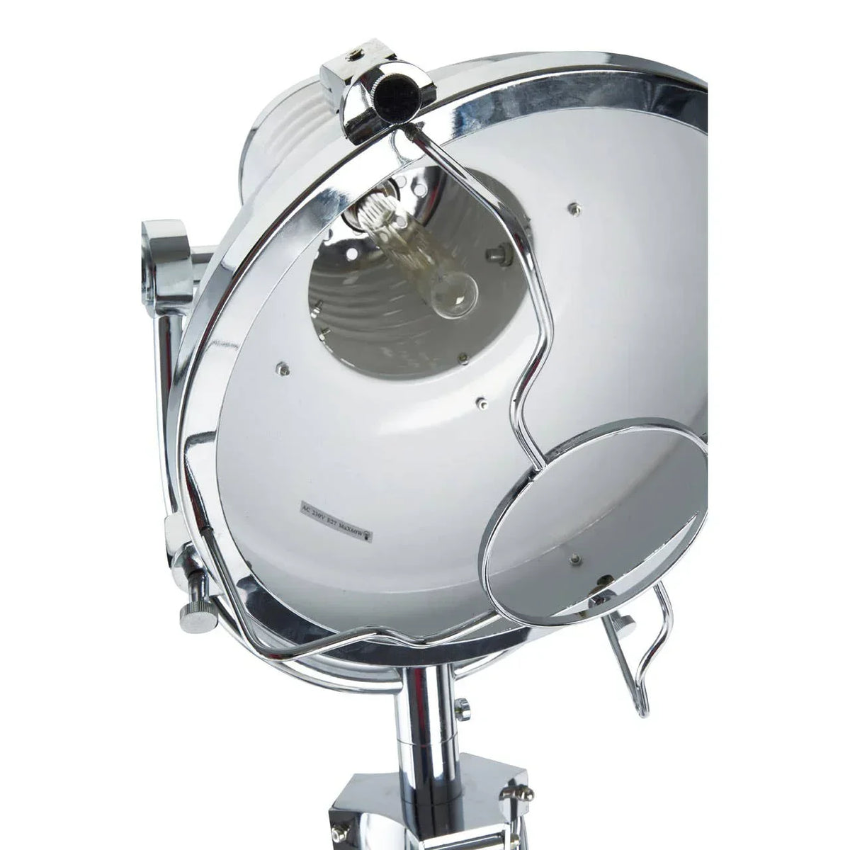 Chrome industrial floor lamp with round head and exposed bulb, close-up view