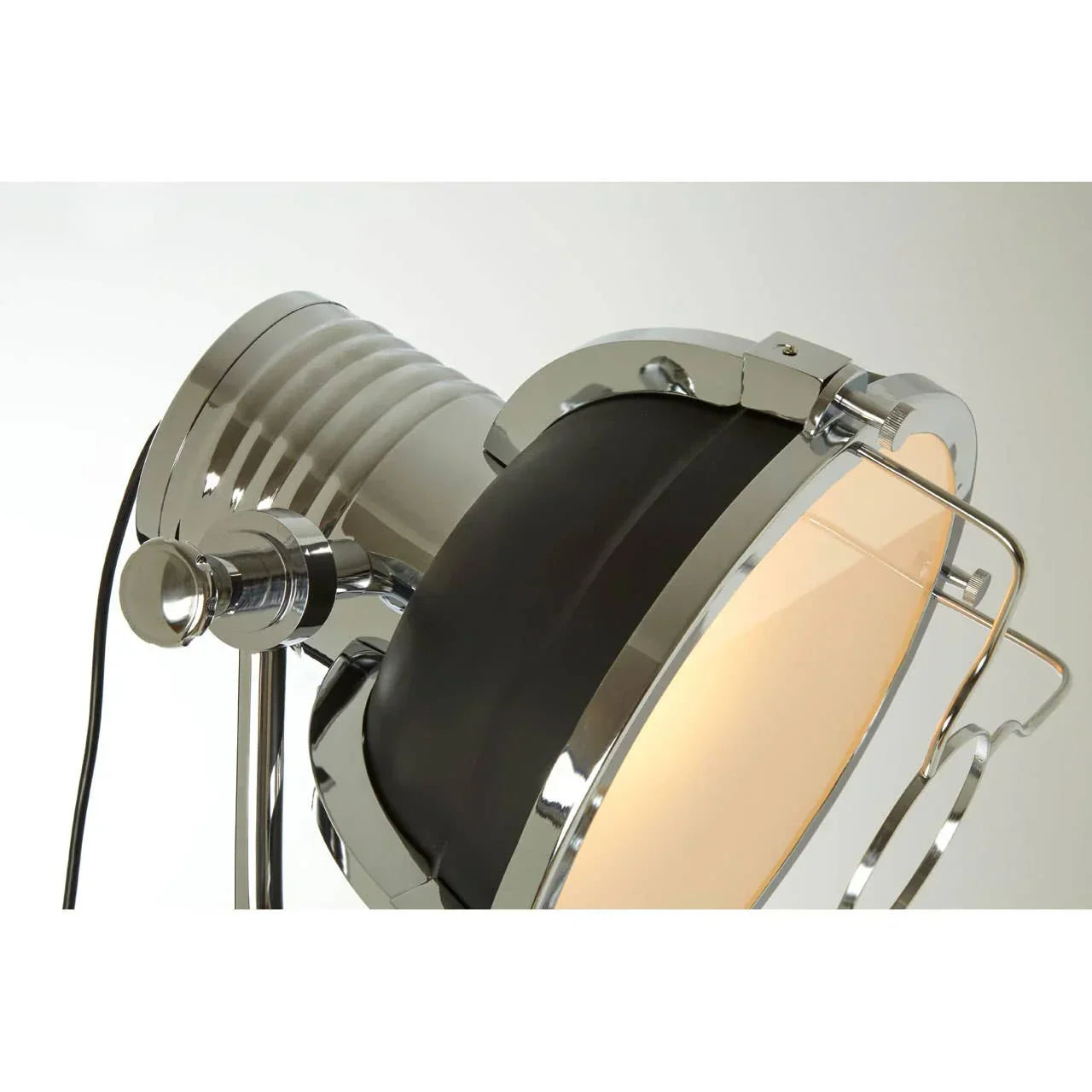 Chrome and black spotlight floor lamp with ribbed metal detail, close-up view