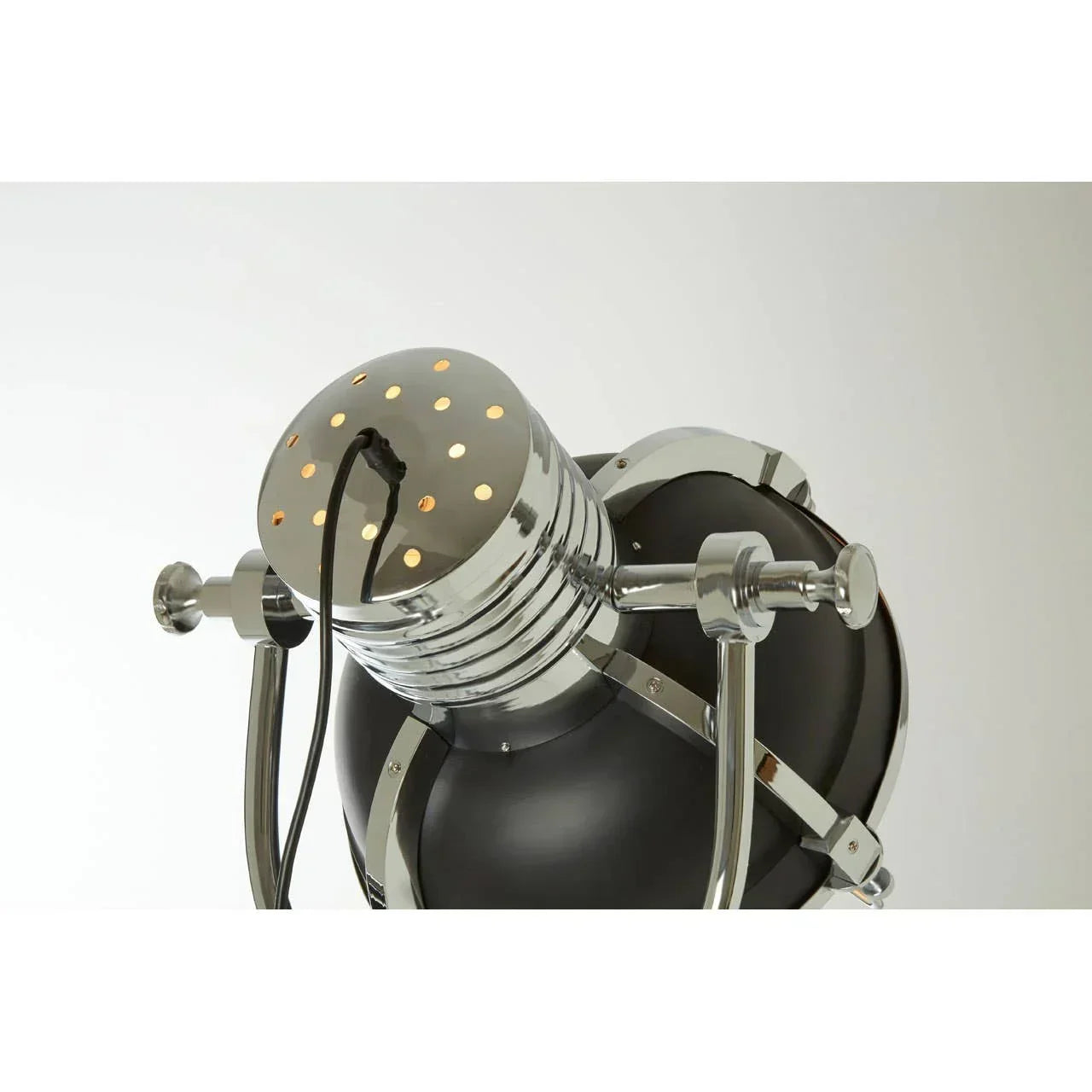 Closeup of industrial black and chrome floor lamp head with adjustable metal arms