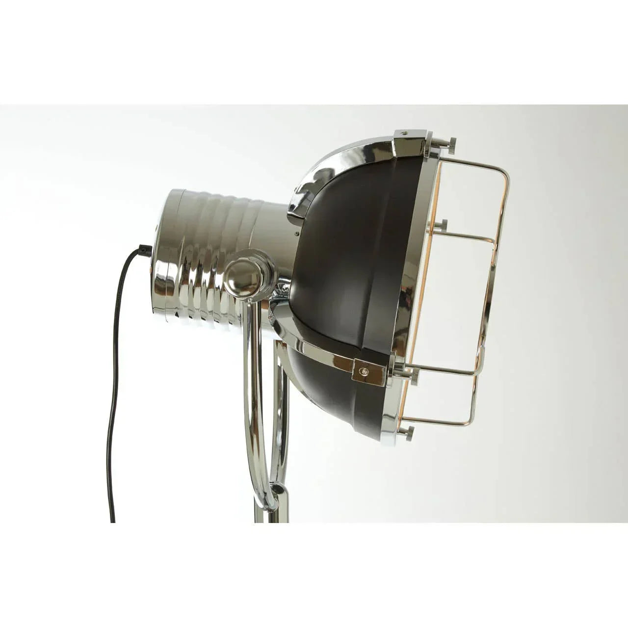 Chrome industrial floor lamp with protective grill and spotlight-style head