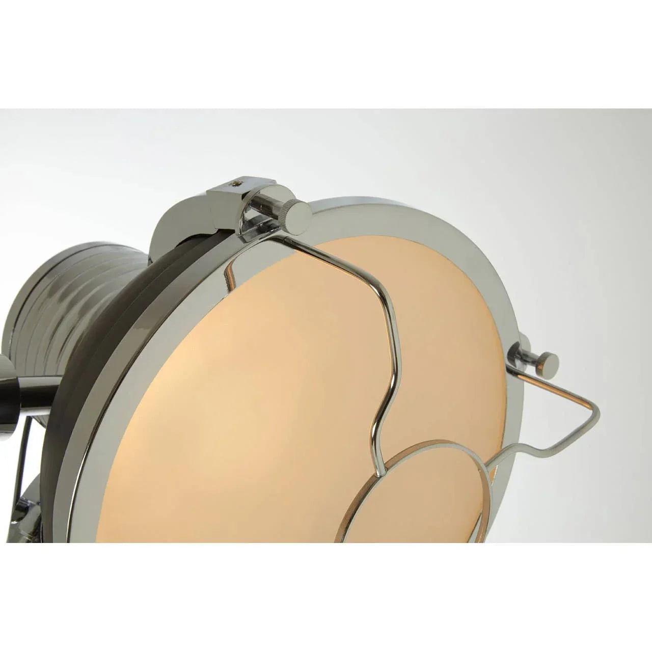 Close view of chrome finish lamp with frosted glass shade and metal detailing