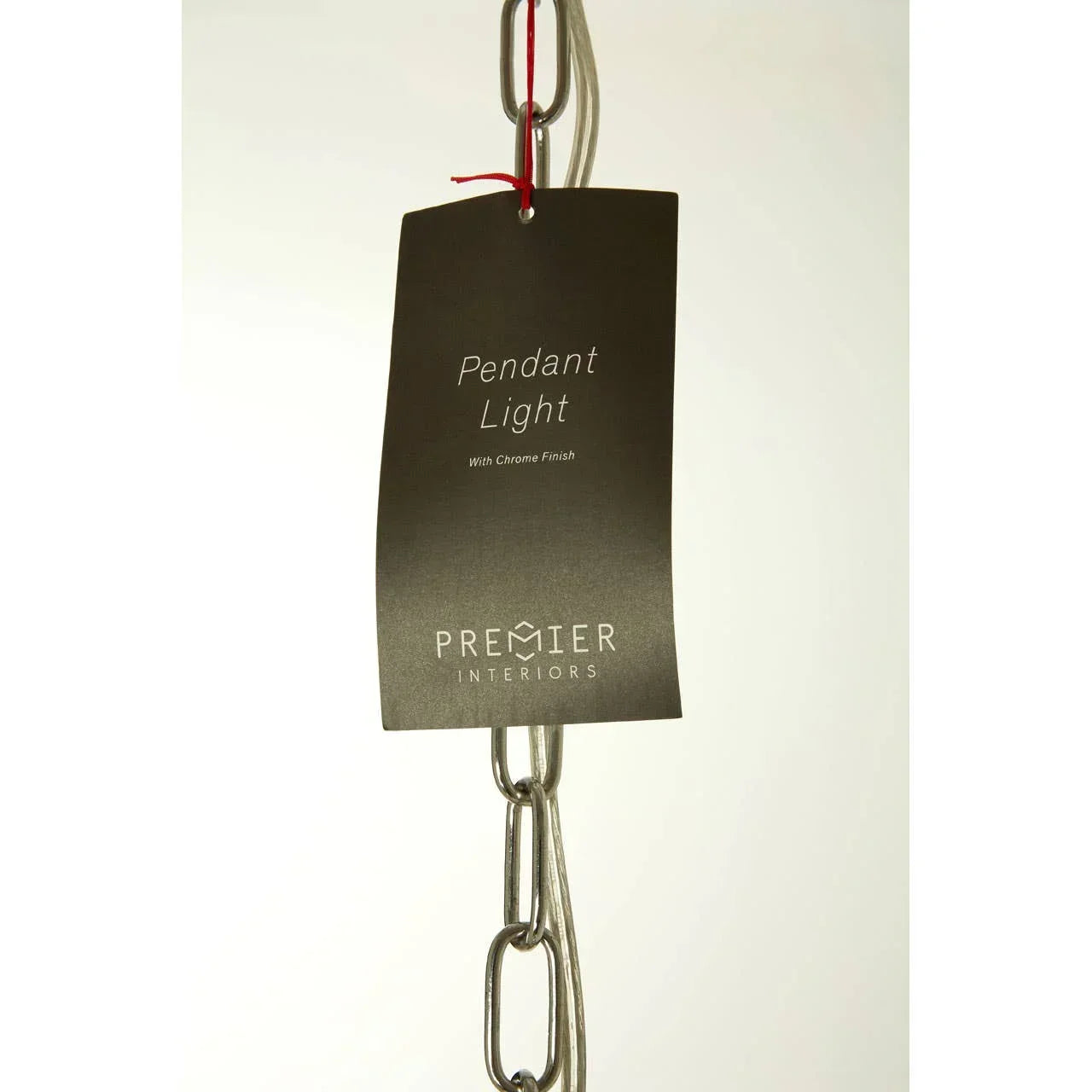 Pendant light with chrome finish on metal chain, Premier Interiors tag attached