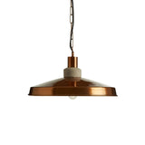 Copper pendant light with wide metal shade and concrete detail, hanging on black chain