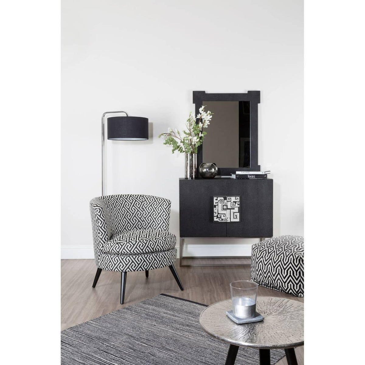 Geometric patterned accent chair and sideboard in modern living room with black floor lamp