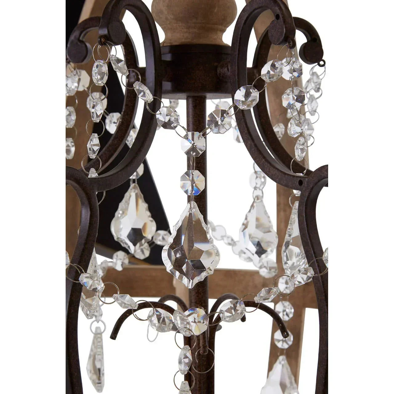 Close up of crystal chandelier with dark metal scroll frame and hanging glass drops