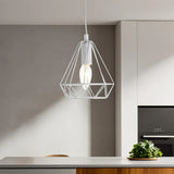 White geometric pendant light over modern kitchen island with green plant decor