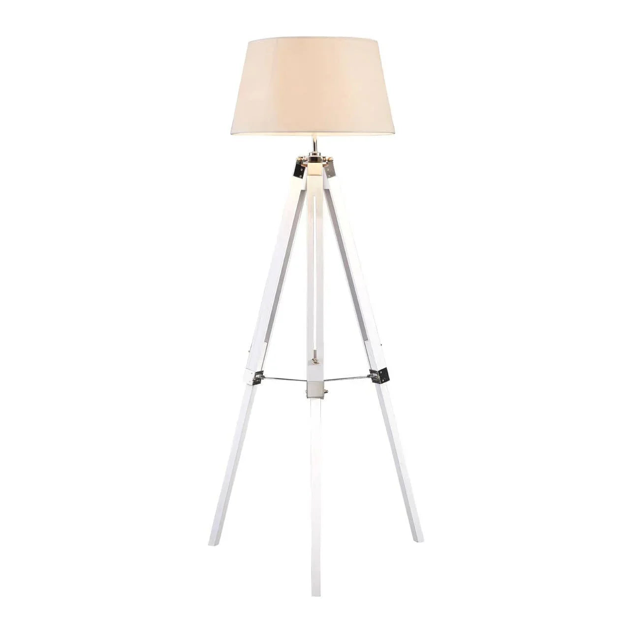 White tripod floor lamp with beige drum shade on white background