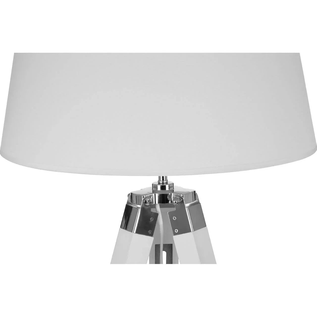 White tripod table lamp with chrome detailing and fabric lampshade, close-up view