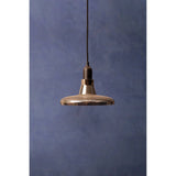 Modern glass pendant light with black fitting against a blue textured wall