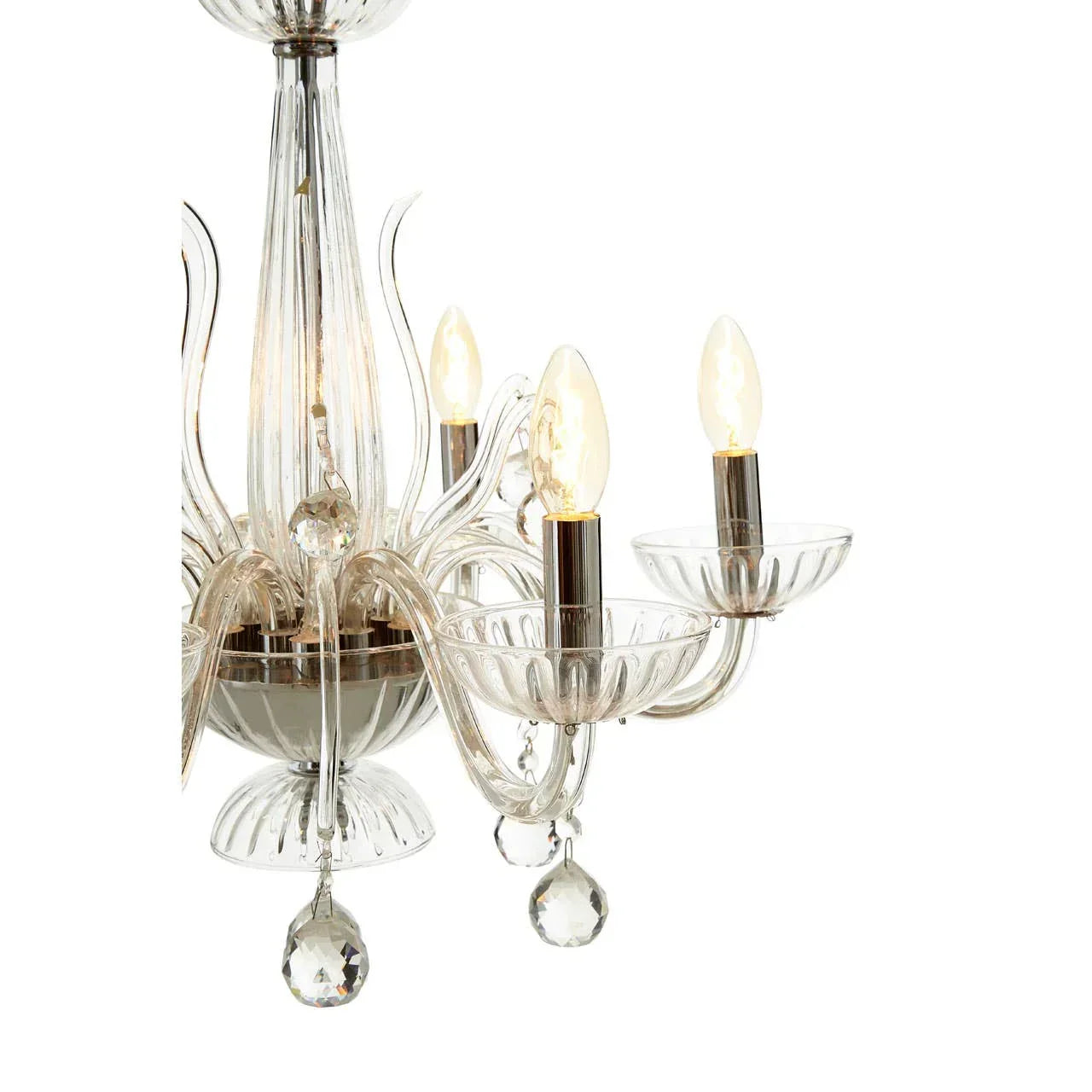 Glass chandelier with crystal accents and three candle bulbs, close-up view