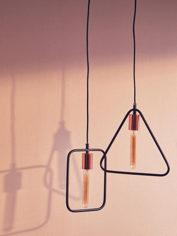 Modern pendant light with rectangular and triangular black frames and exposed bulbs