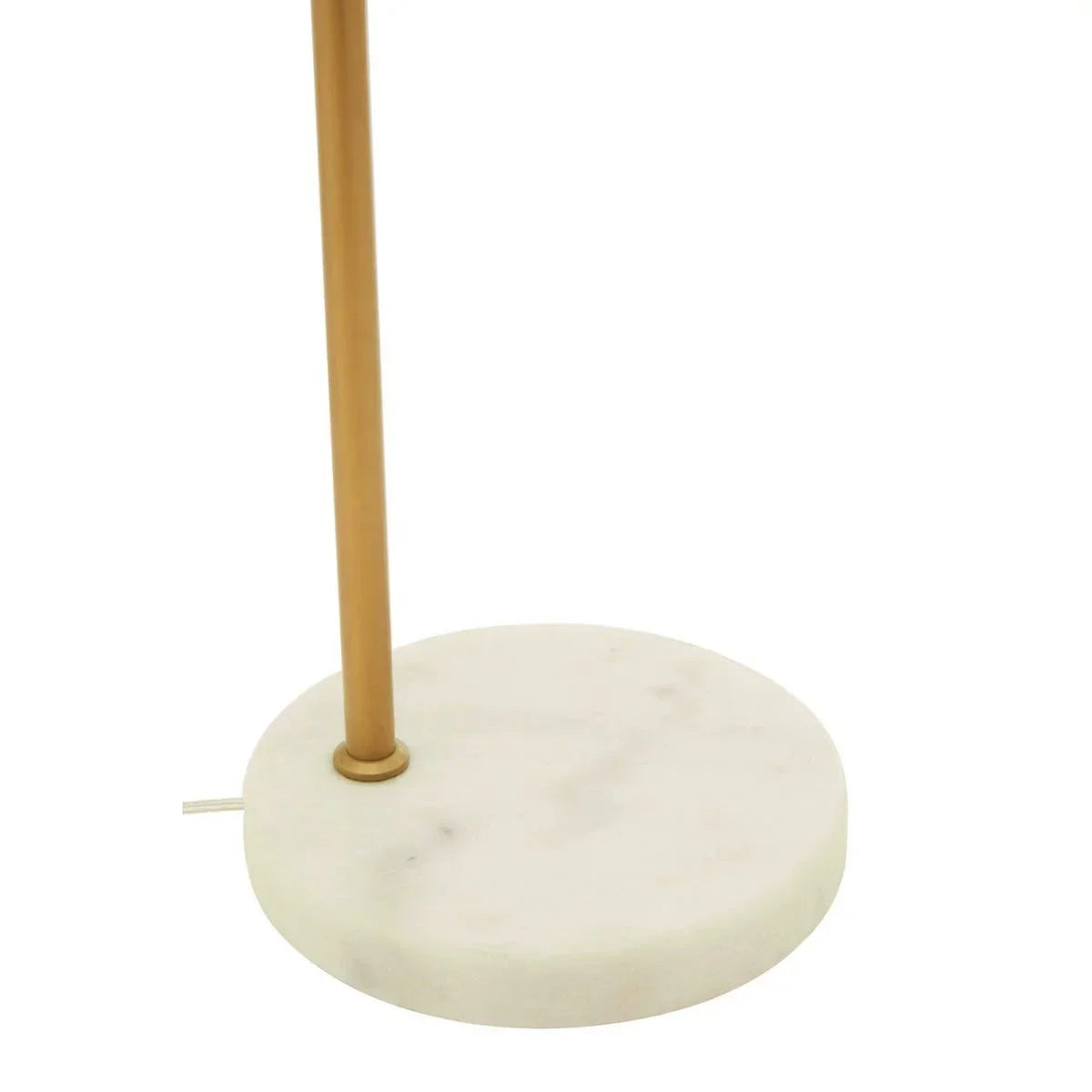 Round white marble lamp base with gold metal stand and visible power cord