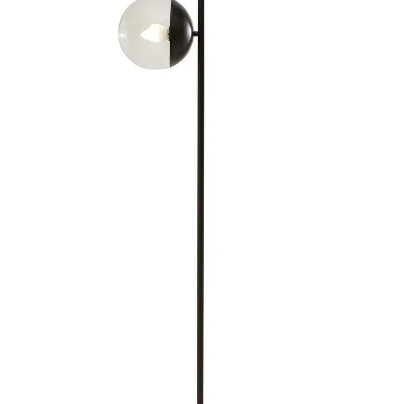 Modern floor lamp with two glass globe shades, black metal stem, and marble base