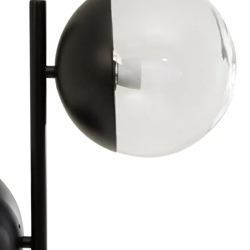 modern glass globe floor lamp with black metal base and clear shade detail