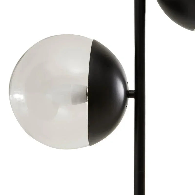 Modern floor lamp with spherical black and white glass shade and metal stem