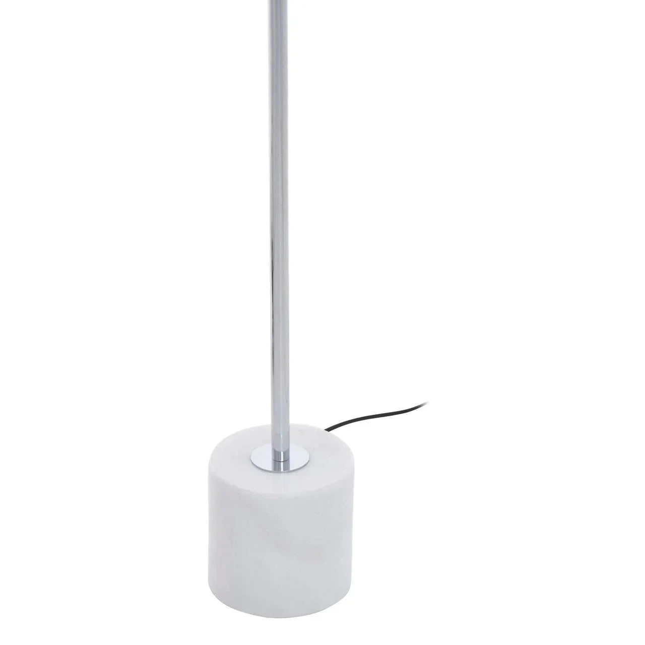 Modern floor lamp with chrome pole and white marble base, black power cord visible