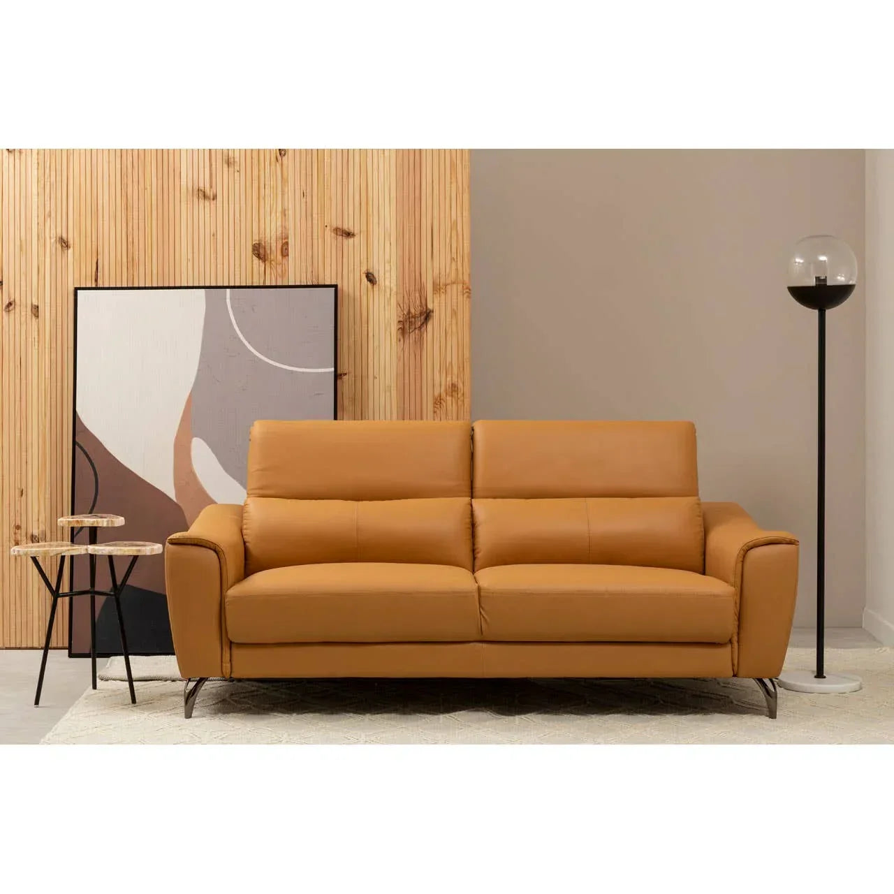 Tan leather sofa with high backrest in modern living room, placed on neutral rug