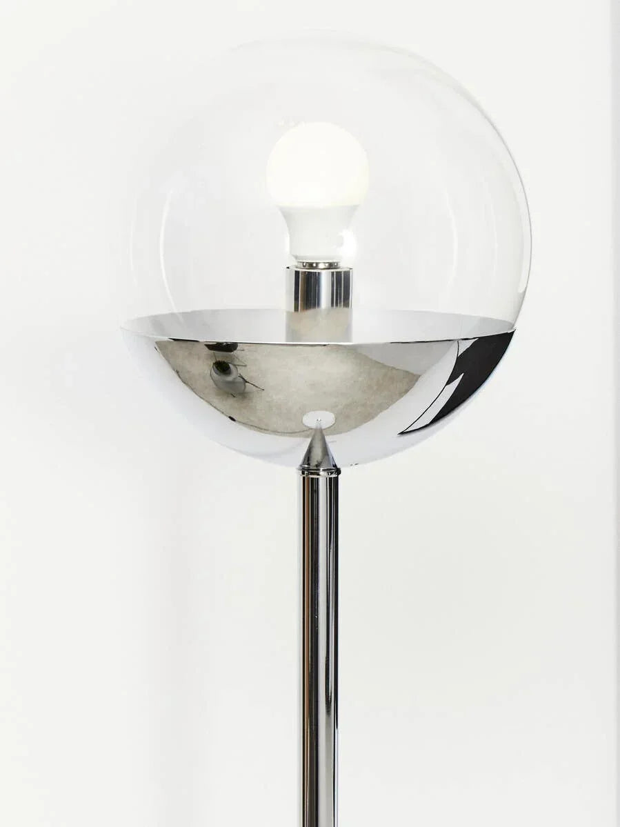 Modern floor lamp with chrome base and clear glass globe shade