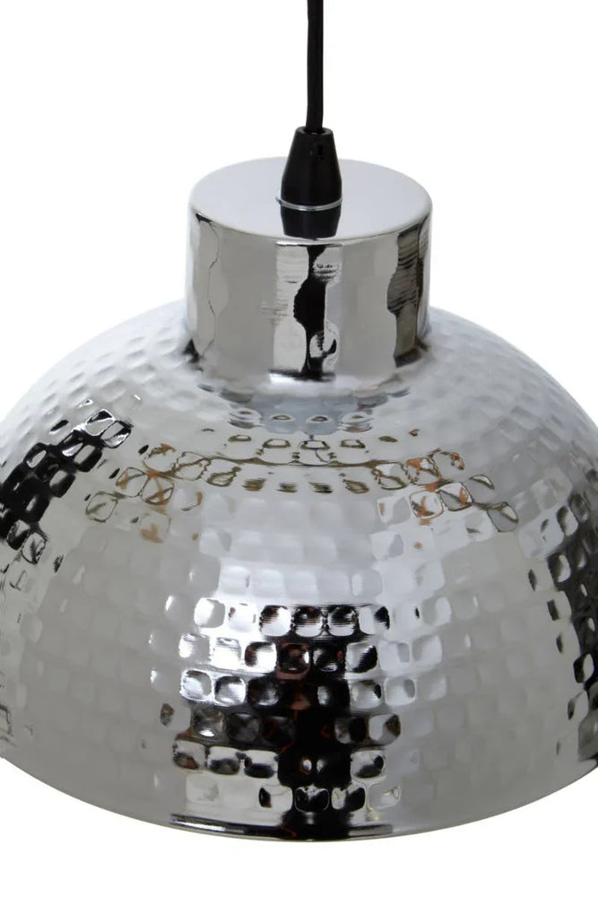 Chrome hammered metal pendant light with black cord, close-up of textured shade