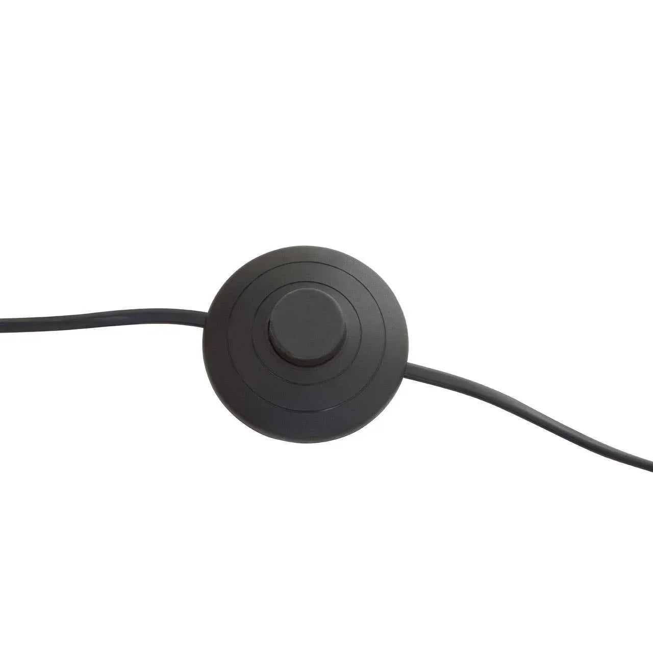 Black floor lamp foot switch with round button and cable on white background