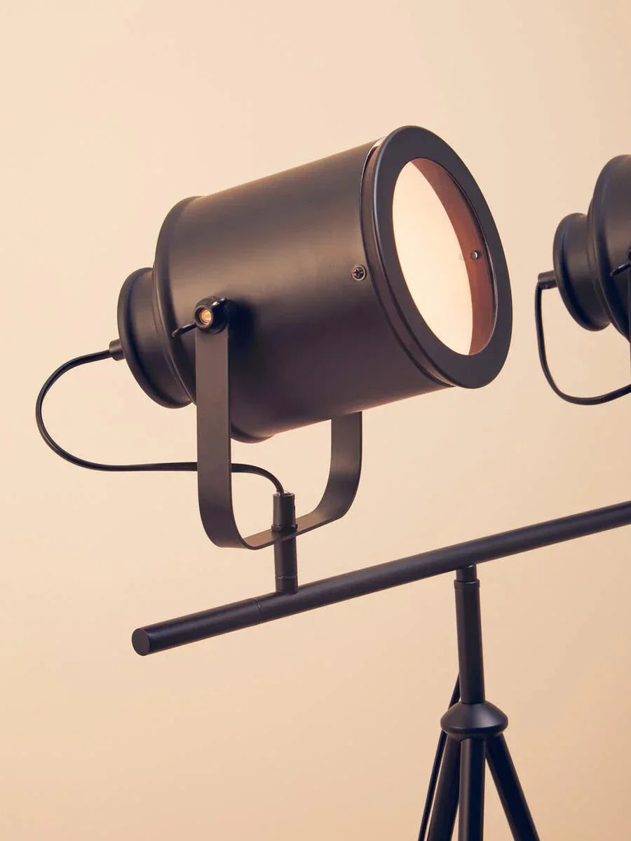 Black metal tripod floor lamp with adjustable spotlight head