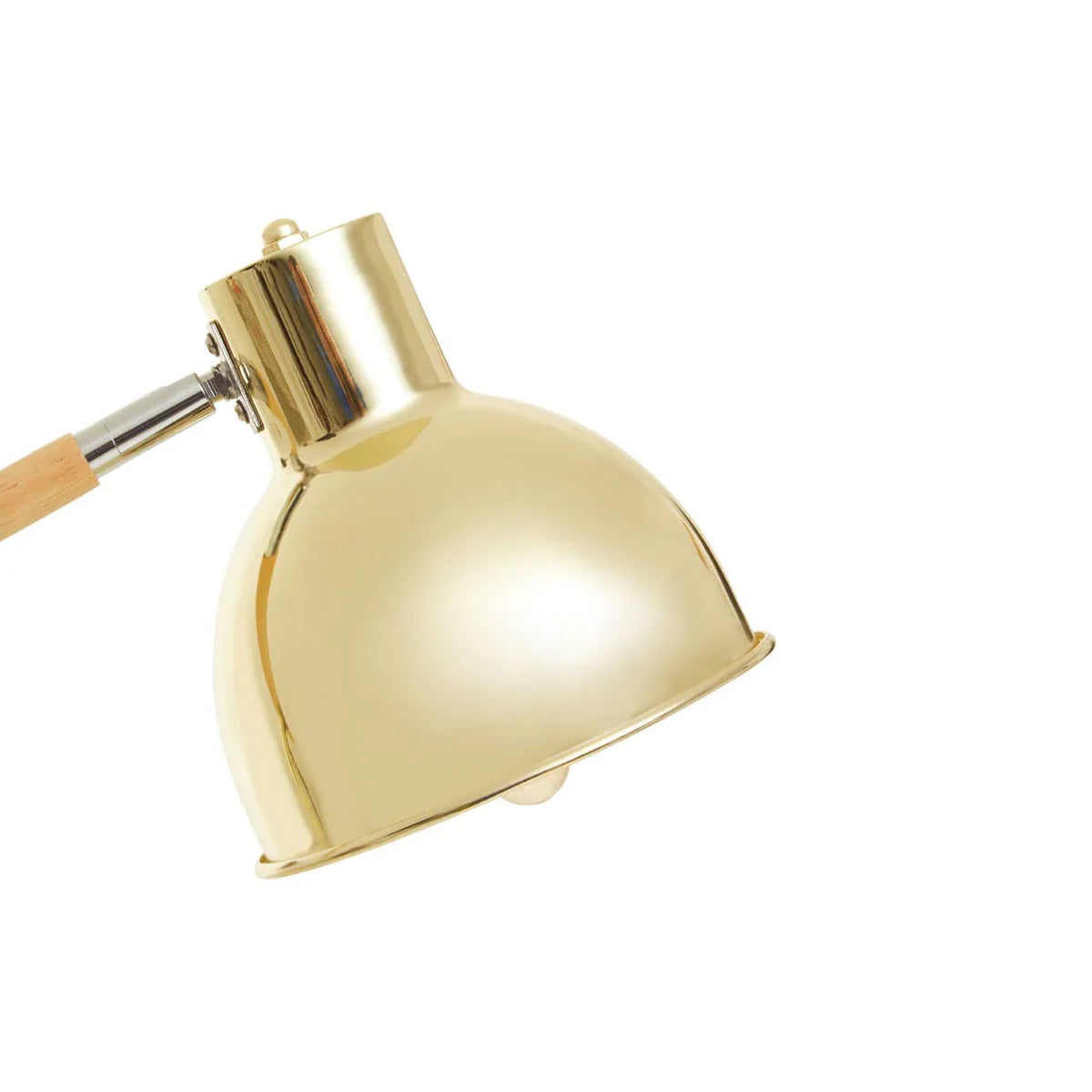 Brass desk lamp shade with wooden arm and chrome accent, close-up side view